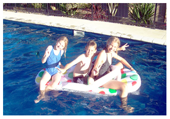 PHOTOALBUM/KIDS BOATING IN THEIR CASCADE SWIMMING POOL